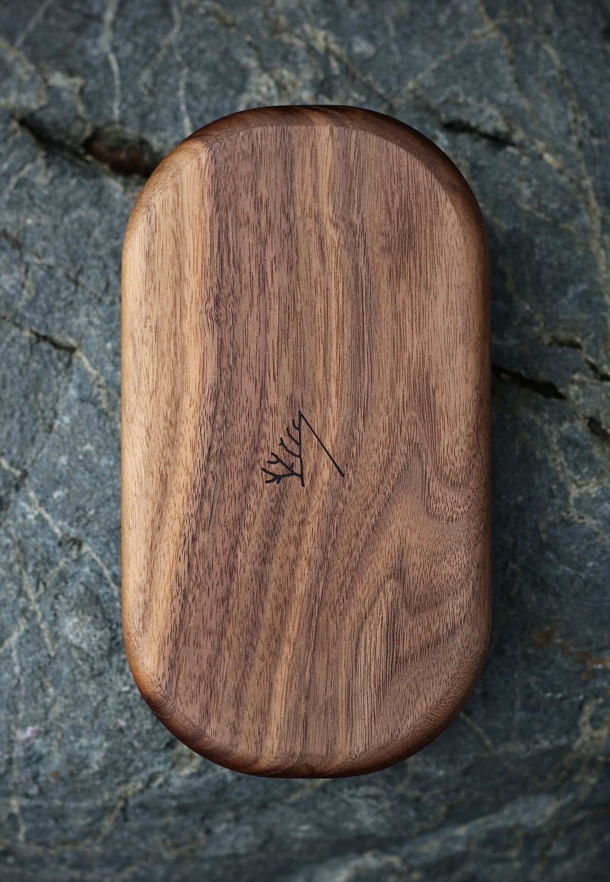 Phone Tomb in walnut, closed, on grey stone